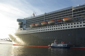 Maid alongside QM2 small